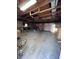 Spacious garage with exposed wood beams, ample storage, and multiple doors offers lots of potential at 360 S Spencer Ave, Indianapolis, IN 46219