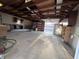 Spacious garage featuring an automatic garage door, cabinets, and fluorescent lighting at 360 S Spencer Ave, Indianapolis, IN 46219