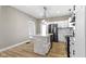 Bright kitchen features a stone-clad island, modern lighting, and stainless-steel appliances at 360 S Spencer Ave, Indianapolis, IN 46219