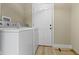 Laundry room showing a white washer and dryer set, and a white door at 360 S Spencer Ave, Indianapolis, IN 46219