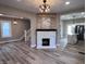 Spacious living room with a cozy fireplace, modern flooring, and an open view into the kitchen area at 360 S Spencer Ave, Indianapolis, IN 46219