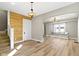 Light-filled living room with stylish wood accent wall, elegant lighting, and cozy window seat at 360 S Spencer Ave, Indianapolis, IN 46219