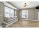 Sunlit living room featuring a window seat, hardwood floors, and modern lighting for a bright and inviting space at 360 S Spencer Ave, Indianapolis, IN 46219