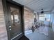 Charming enclosed porch featuring a seating area, natural light, and inviting decor at 360 S Spencer Ave, Indianapolis, IN 46219