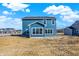 Backyard with a new two-story blue home, featuring a view of the surrounding residential community at 3667 Thomas Jefferson St, Westfield, IN 46074