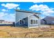 Exterior side view showcases a two-story home with a small patio and neighborhood homes at 3667 Thomas Jefferson St, Westfield, IN 46074