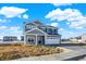 Charming two-story home with stone accents and a two-car garage, set against a blue sky with clouds at 3667 Thomas Jefferson St, Westfield, IN 46074
