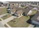 An elevated shot of a home in a neighborhood of similarly styled homes with driveways and grassy front yards at 3677 Cedar Cove Ct, New Palestine, IN 46163