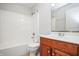 Bathroom with white tub and shower combination, vanity with wood cabinets and tile floor at 3677 Cedar Cove Ct, New Palestine, IN 46163