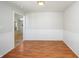 Dining room with hardwood floors, wainscoting, and a view into another living area at 3677 Cedar Cove Ct, New Palestine, IN 46163