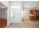 Bright entryway boasts new floors, a front door with decorative window and adjacent kitchen area at 3677 Cedar Cove Ct, New Palestine, IN 46163