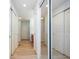 Bright hallway with wood floors, access to a bathroom and closet with mirrored doors at 3677 Cedar Cove Ct, New Palestine, IN 46163