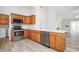 Well-lit kitchen showcasing ample counter space, modern appliances, and stylish cabinetry at 3677 Cedar Cove Ct, New Palestine, IN 46163