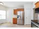 Updated kitchen showcases stainless steel refrigerator and a neutral color palette at 3677 Cedar Cove Ct, New Palestine, IN 46163