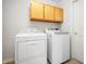 Laundry room with white washer and dryer and overhead cabinets at 3677 Cedar Cove Ct, New Palestine, IN 46163