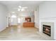 Open-concept living area connects to the kitchen, featuring a cozy fireplace at 3677 Cedar Cove Ct, New Palestine, IN 46163