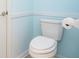 Close up of a standard toilet in a bathroom with light blue walls and white trim at 3677 Cedar Cove Ct, New Palestine, IN 46163
