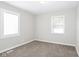 Neutral carpeted bedroom featuring two windows providing natural light and neutral walls and base trim at 3732 Wellington Ave, Indianapolis, IN 46226