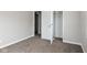 Neutral bedroom featuring carpeting, a closet, base trim, and an interior door at 3732 Wellington Ave, Indianapolis, IN 46226