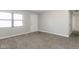Bright, carpeted bedroom featuring a window, neutral walls, and a modern interior door at 3732 Wellington Ave, Indianapolis, IN 46226