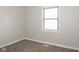Neutral carpeted bedroom featuring a window providing natural light, neutral walls and base trim at 3732 Wellington Ave, Indianapolis, IN 46226