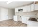White kitchen with laminate flooring and modern appliances at 3732 Wellington Ave, Indianapolis, IN 46226