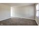 Neutral living room featuring carpet and white trim, illuminated by natural light from a window at 3732 Wellington Ave, Indianapolis, IN 46226
