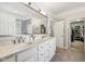 This bathroom has a double vanity, and a glass enclosed shower with glass block window at 4215 Heyward Pl, Indianapolis, IN 46250