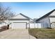 Home featuring a well-maintained lawn, fenced-in area, and a convenient two-car garage at 4215 Heyward Pl, Indianapolis, IN 46250