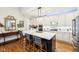 Kitchen island with seating, stainless steel appliances, and hardwood flooring at 4215 Heyward Pl, Indianapolis, IN 46250