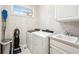 Functional laundry room featuring modern washer and dryer, utility sink, and ample cabinet space for storage at 4215 Heyward Pl, Indianapolis, IN 46250