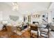 Open-concept living and dining area with hardwood floors and fireplace at 4215 Heyward Pl, Indianapolis, IN 46250