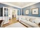 This living room has blue accent wall, white trim and french doors at 4215 Heyward Pl, Indianapolis, IN 46250