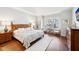 This main bedroom features hardwood floors, sitting area and lots of light at 4215 Heyward Pl, Indianapolis, IN 46250