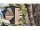 An aerial shot of the roof of a well maintained home with an attached patio and fenced-in yard and bordering trees at 5115 Baltustrol Dr, Avon, IN 46123