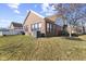 Backyard view of brick house and open yard space at 5115 Baltustrol Dr, Avon, IN 46123