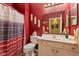 Bathroom with red wall, shower and vanity at 5115 Baltustrol Dr, Avon, IN 46123