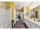 Hallway bathroom featuring double sinks, spacious vanity, tile floors, and a walk-in shower at 5115 Baltustrol Dr, Avon, IN 46123