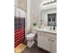 Cozy bathroom featuring a white vanity, toilet, shower with striped curtain, and neutral walls at 5115 Baltustrol Dr, Avon, IN 46123