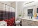 Cozy bathroom featuring a white vanity, toilet, shower with striped curtain, and neutral walls at 5115 Baltustrol Dr, Avon, IN 46123
