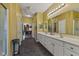 Bright bathroom with double vanity sinks, large mirrors, tile flooring, and walk-in closet access at 5115 Baltustrol Dr, Avon, IN 46123