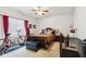 Bright bedroom with a dark wood bed frame, ceiling fan, and natural light from the window at 5115 Baltustrol Dr, Avon, IN 46123