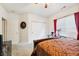 Bright bedroom with a dark wood bed frame, ceiling fan, and natural light from the window at 5115 Baltustrol Dr, Avon, IN 46123