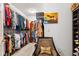 Walk-in closet with organized shelving, hanging rods, and a cozy armchair at 5115 Baltustrol Dr, Avon, IN 46123