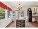 Well-lit dining area with modern chandelier and elegant furniture near the kitchen at 5115 Baltustrol Dr, Avon, IN 46123