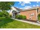 Well-maintained single-story brick home featuring manicured landscaping, a tidy lawn, and classic architectural elements at 5115 Baltustrol Dr, Avon, IN 46123