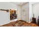 Inviting foyer with hardwood floors, coat rack, and office access provides a warm welcome to this lovely home at 5115 Baltustrol Dr, Avon, IN 46123