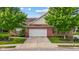 Charming single-story brick home featuring an attached garage and a beautifully landscaped front yard with mature trees at 5115 Baltustrol Dr, Avon, IN 46123