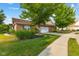 This single-story brick home has an attached garage, mature trees, and a well-manicured lawn for beautiful curb appeal at 5115 Baltustrol Dr, Avon, IN 46123