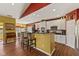 Bright kitchen area featuring counter seating, white cabinets, and views into the dining area at 5115 Baltustrol Dr, Avon, IN 46123